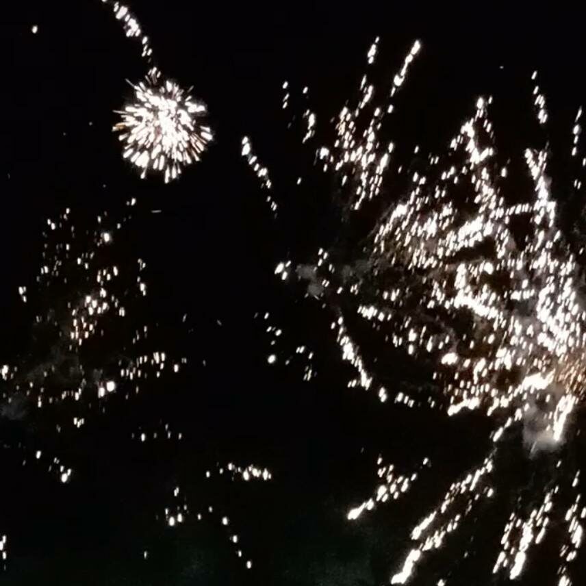 Vivid fireworks explode against a dark night sky above Lear House, with scattered sparks fanning outward—ideal for safe celebrations on Bonfire Night.