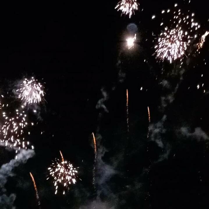 Colourful fireworks burst and illuminate the night sky on Bonfire Night, with trails of smoke and sparks creating a vibrant scene ideal for safe celebrations.