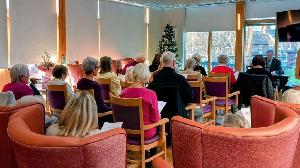 A group of people seated in chairs.