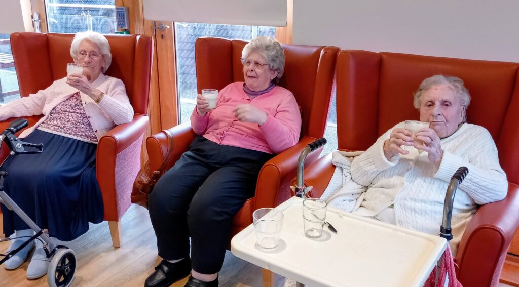 Two women sitting on chairs.
