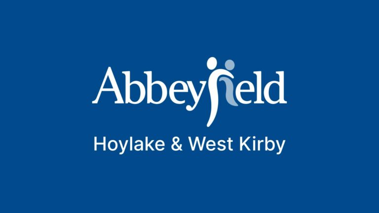 Abbeyfield Hoylake & West Kirby logo on a blue background, with stylised human figures incorporated into the letter 'f' in Abbeyfield.